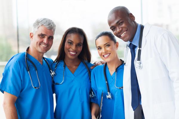 Nurses and medical doctor standing next to each other.