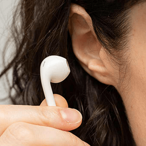 woman inserting earphones