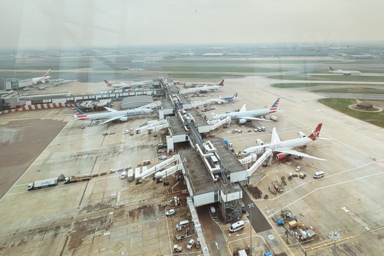 Aerial view of airplanes parked at airport gates.