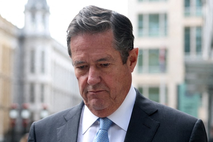 Jes Staley walking near a court.