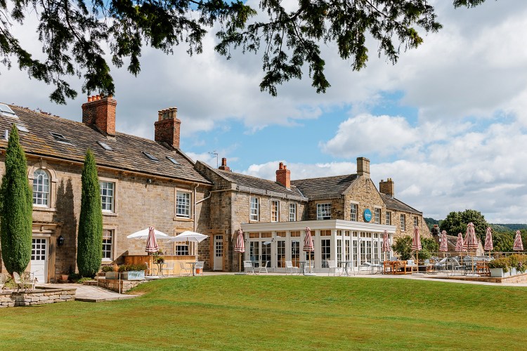 The Cavendish Hotel in Baslow, showing its garden room terrace and outdoor seating area.