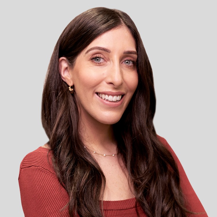 a woman with long brown hair is smiling for the camera